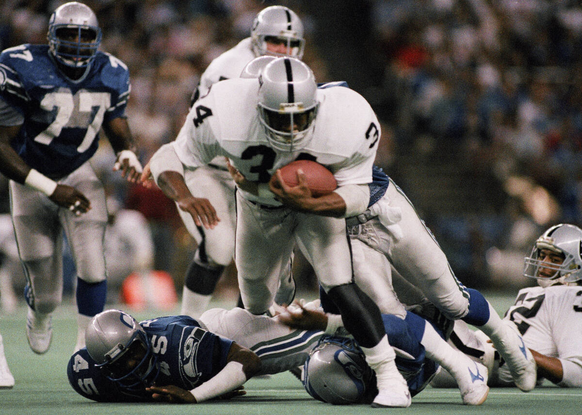 Los Angeles Raiders Bo Jackson (34) runs over Seattle Kenny Easley (45) for a 12 yard gain in t ...