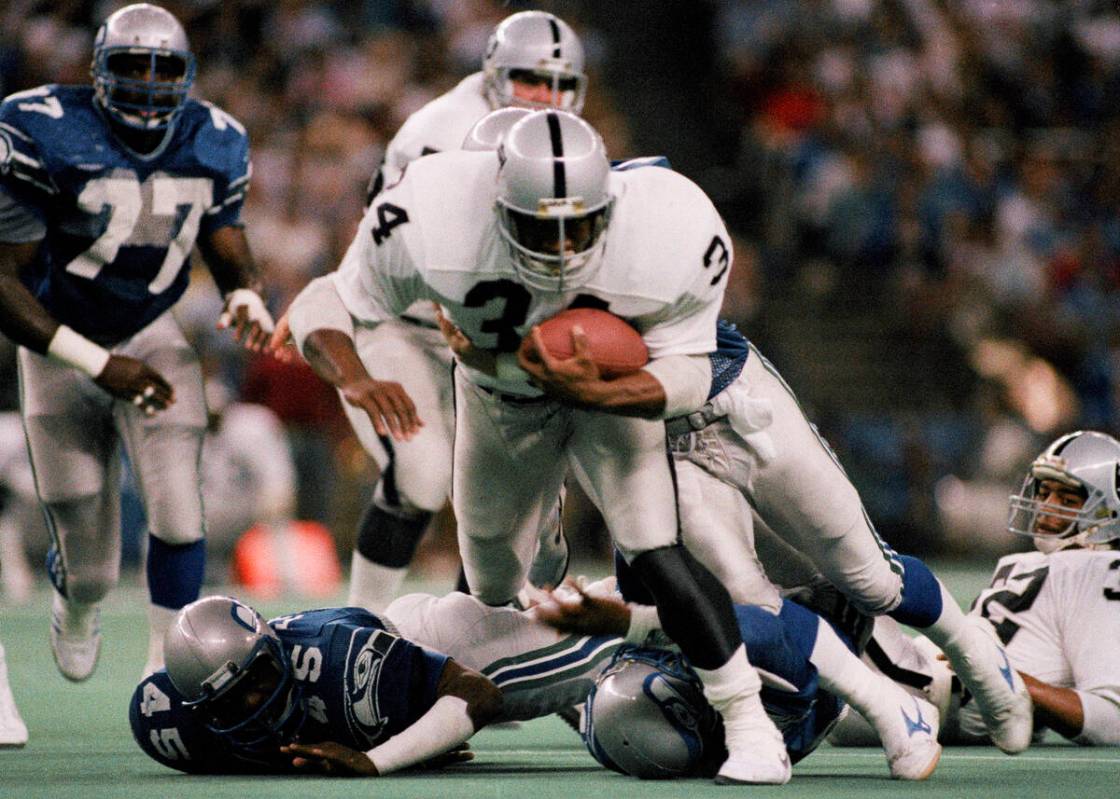 Los Angeles Raiders Bo Jackson (34) runs over Seattle Kenny Easley (45) for a 12 yard gain in t ...