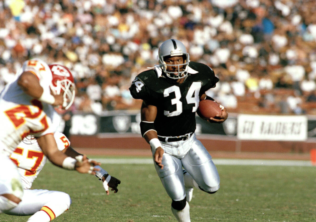 Running back Bo Jackson (34) of the Los Angeles Raiders carries the ball during a game against ...