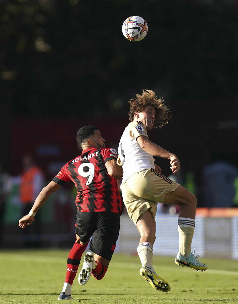 Bournemouth's Dominic Solanke, left, and Leicester City's Wout Faes battle for the ball during ...