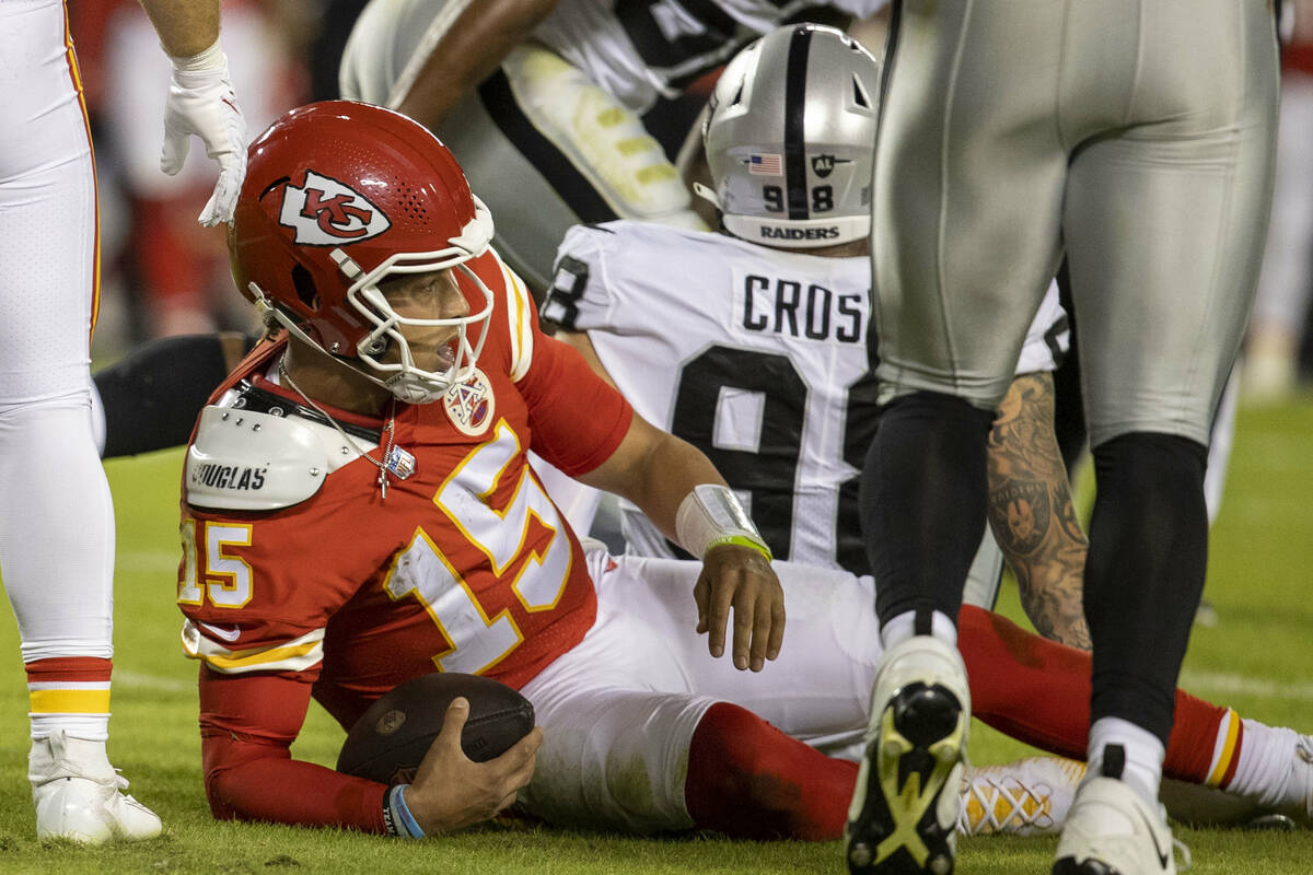 Kansas City Chiefs quarterback Patrick Mahomes (15) is sacked by Raiders defensive end Maxx Cro ...