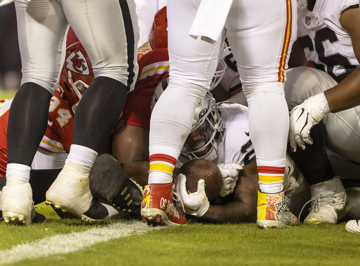 Raiders running back Josh Jacobs (28) is stopped short of the end zone by the Kansas City Chief ...