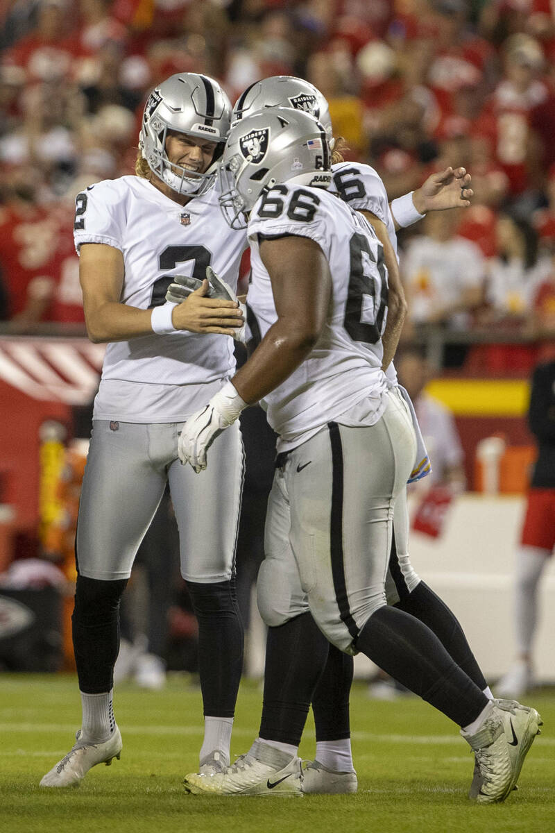 Raiders place kicker Daniel Carlson (2) is congratulated by offensive lineman Dylan Parham (66) ...