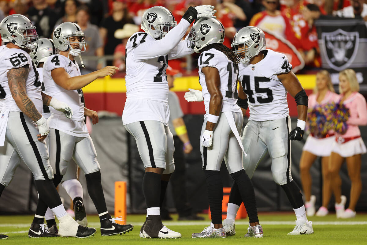 Raiders wide receiver Davante Adams (17) celebrates his touchdown catch with offensive tackle T ...