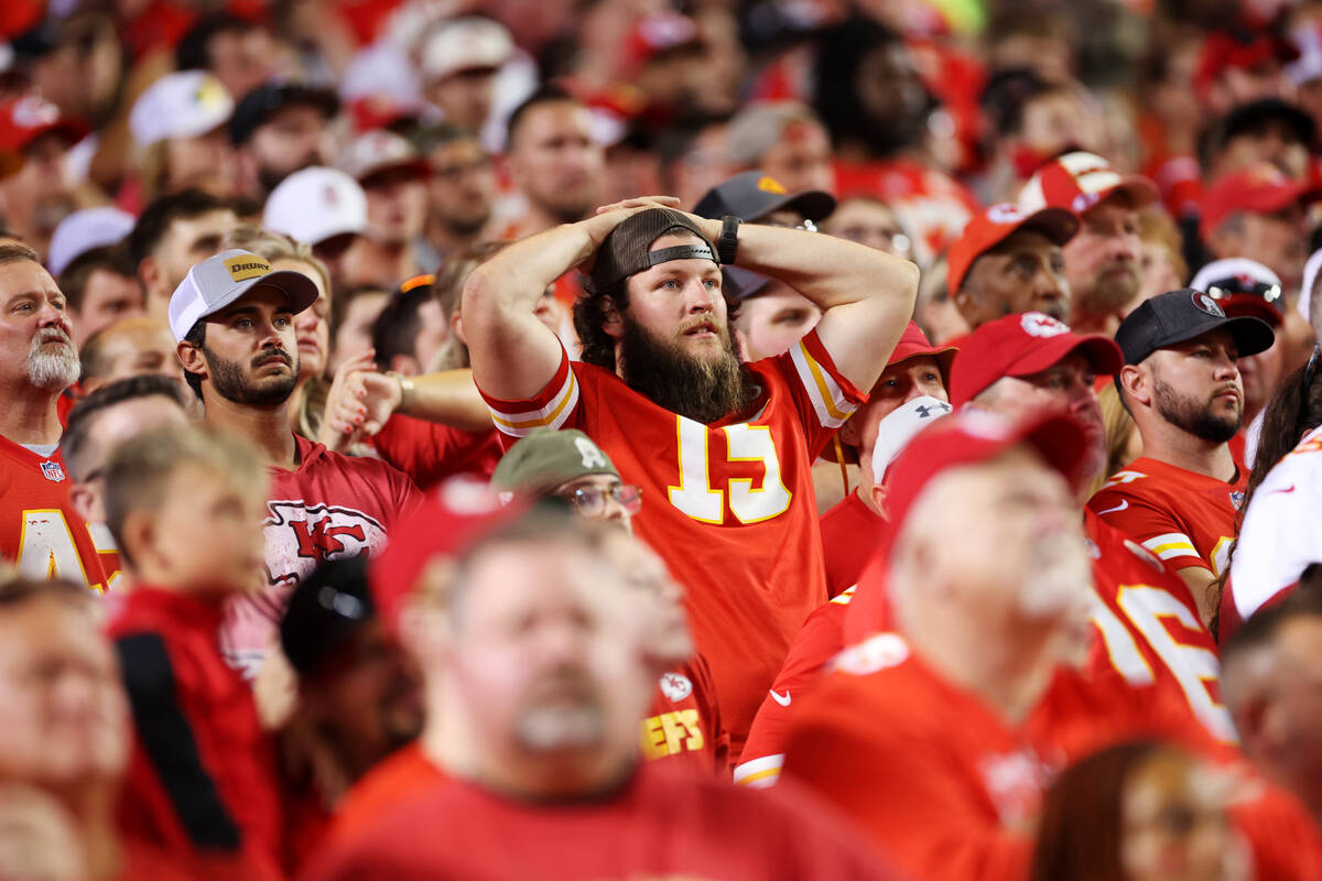 Fans react after a plays during the first half of a NFL football game between the Raiders and t ...