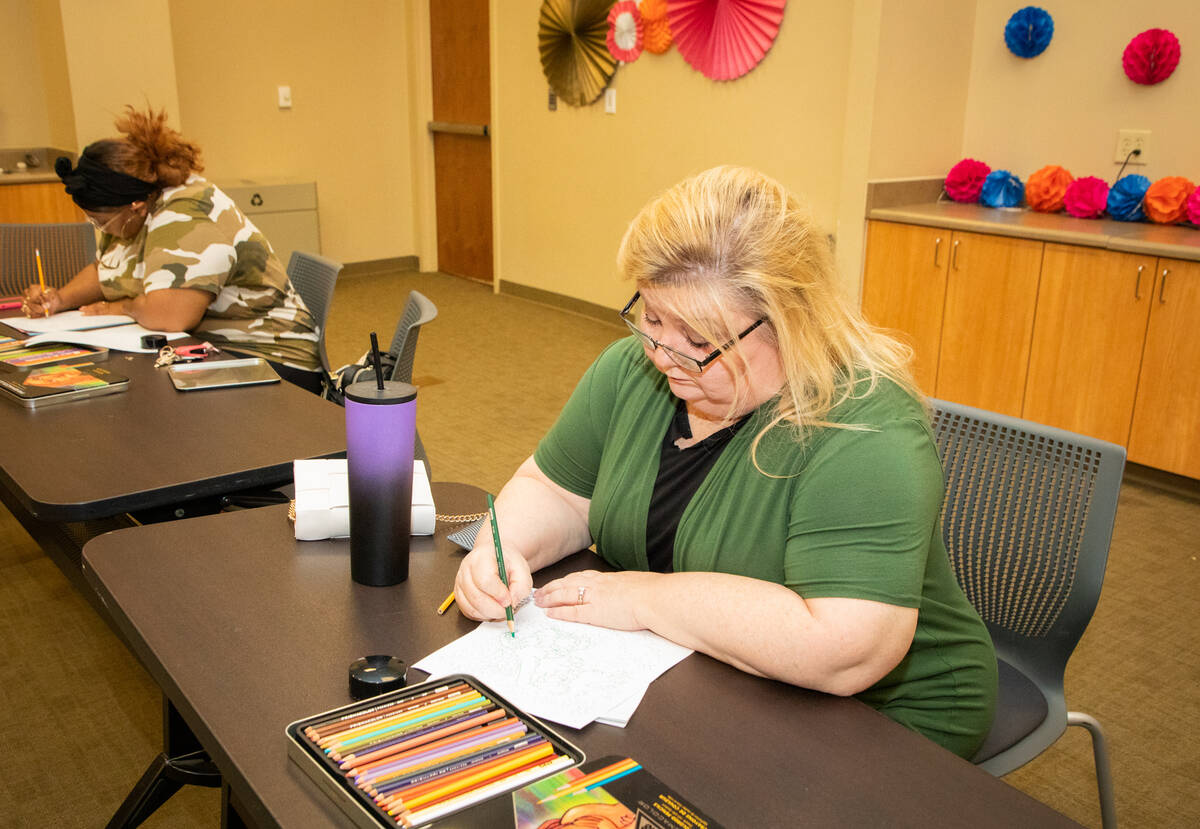 Participants Royneqiuea Fields, left, and Jackie Heier, right, work on coloring activities duri ...