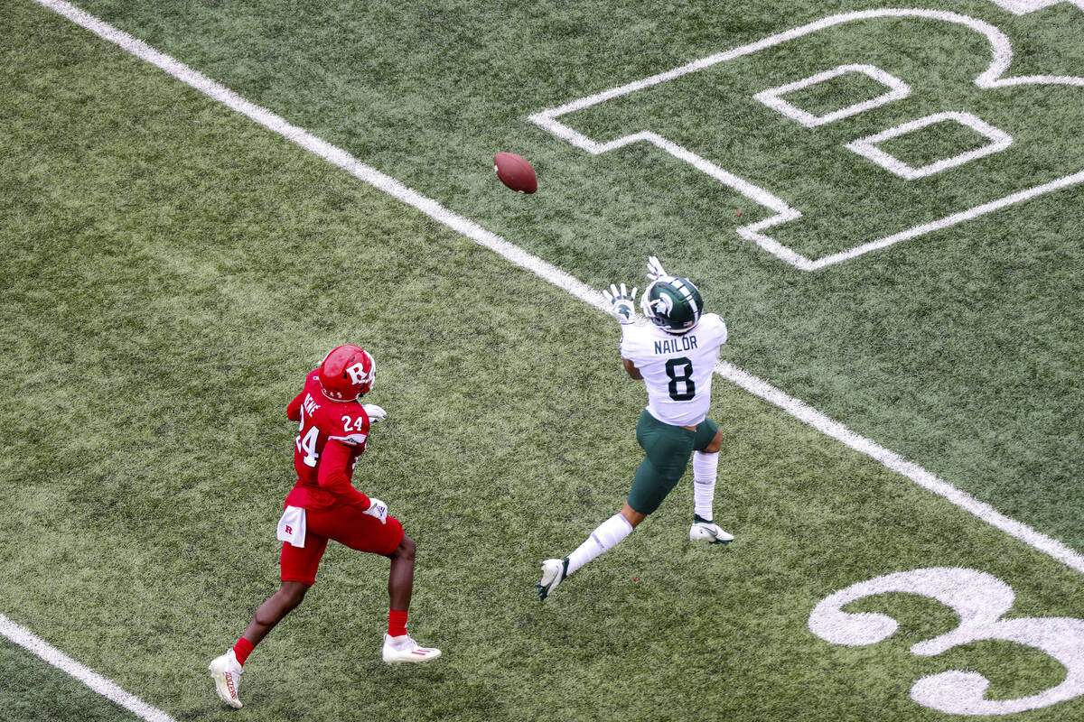 Michigan State wide receiver Jalen Nailor (8) beats Rutgers defensive back Patrice Rene (24) to ...