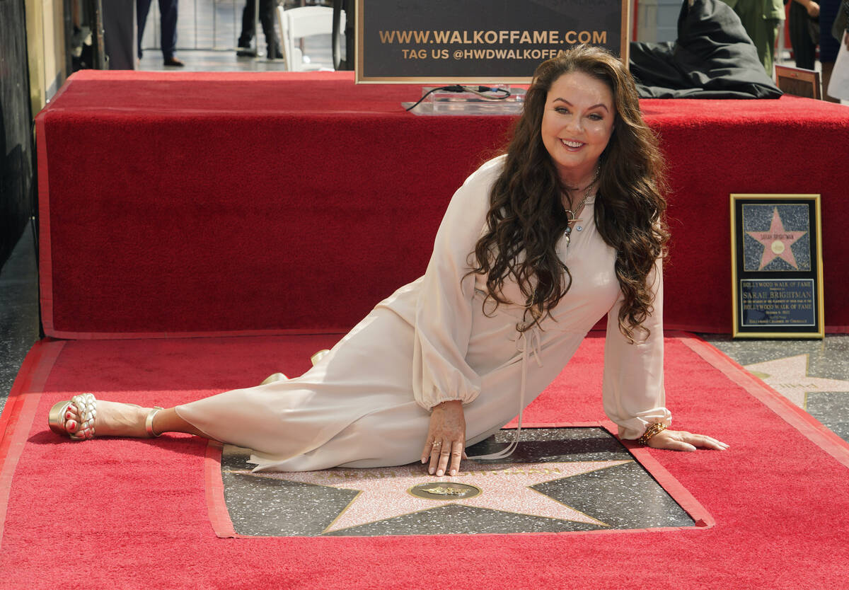 Singer/actress Sarah Brightman poses on her new star on the Hollywood Walk of Fame during a cer ...