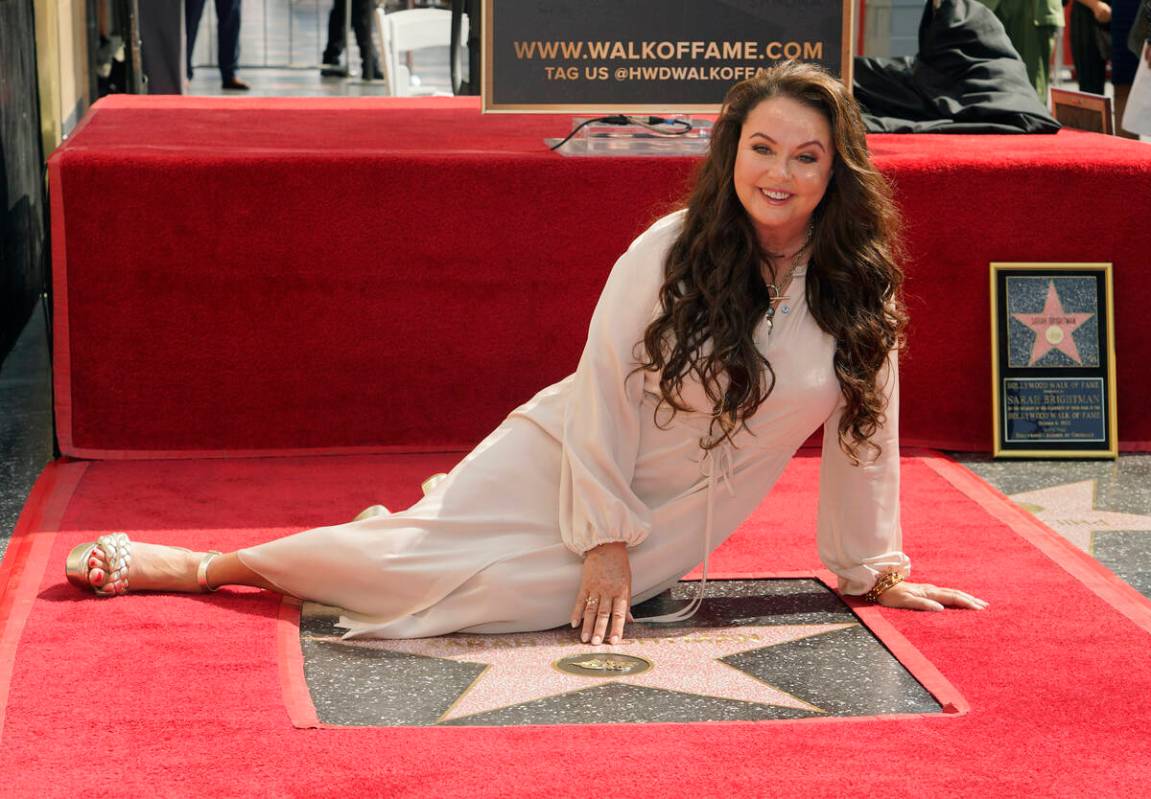 Singer/actress Sarah Brightman poses on her new star on the Hollywood Walk of Fame during a cer ...