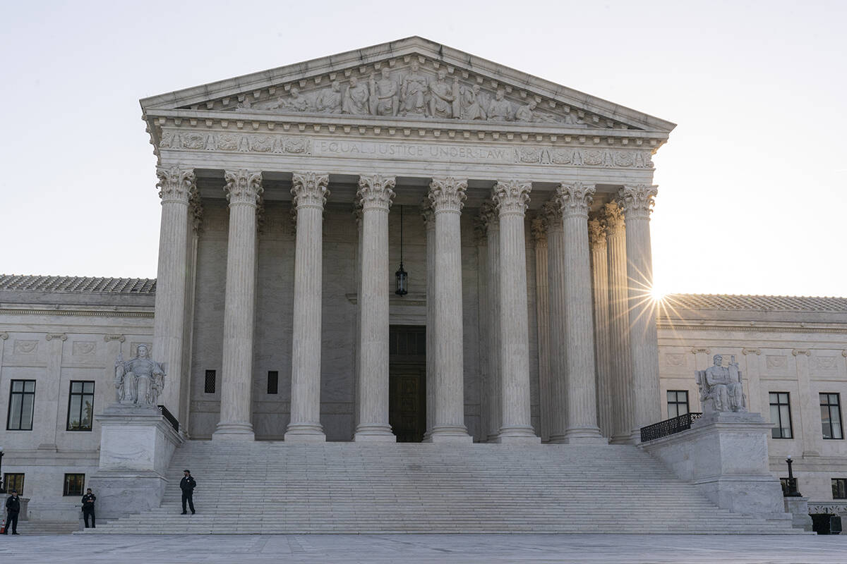 The sun rises behind the U.S. Supreme Court, Tuesday, Oct. 11, 2022, in Washington. The Biden a ...