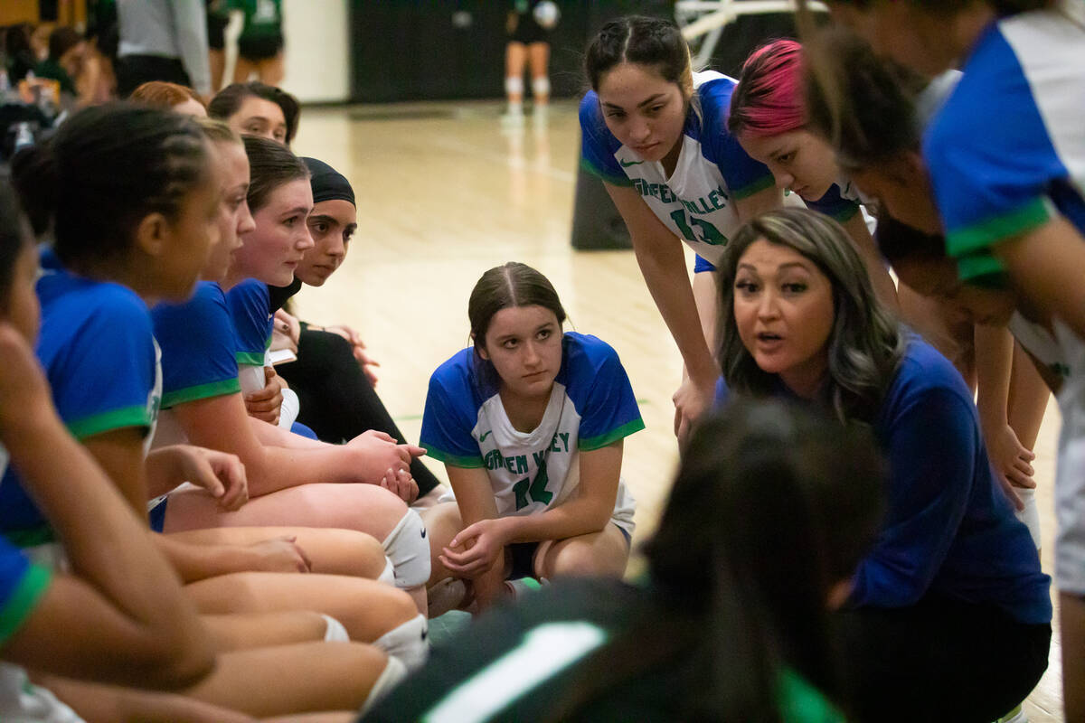 Green Valley team members listen to their coach in between sets at a volleyball game at Palo Ve ...