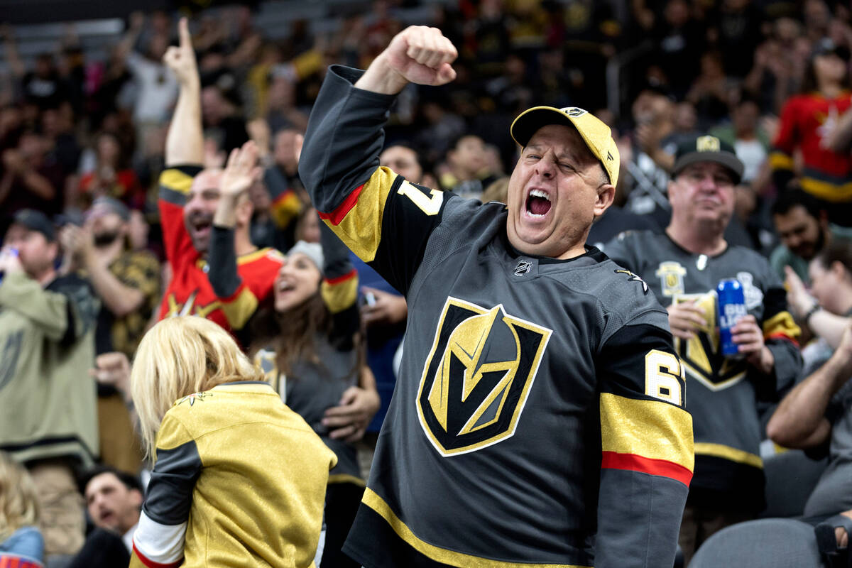 A Golden Knights fan cheers after his team scored during the second period of a preseason NHL h ...