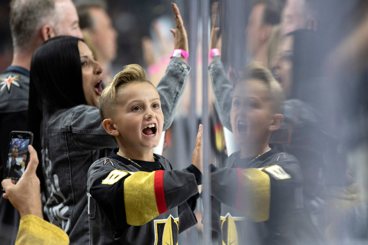 Golden Knights fans slam their hands against the boards after their team scored during the seco ...