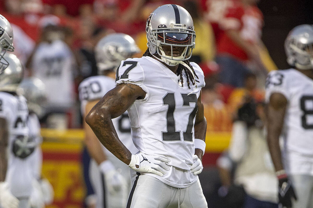 Raiders wide receiver Davante Adams (17) stretches before an NFL game against the Kansas City C ...