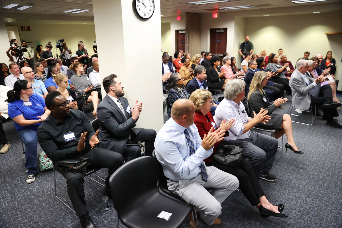 Attendees applaud during a press conference announcing the Eviction Diversion Initiate court pr ...