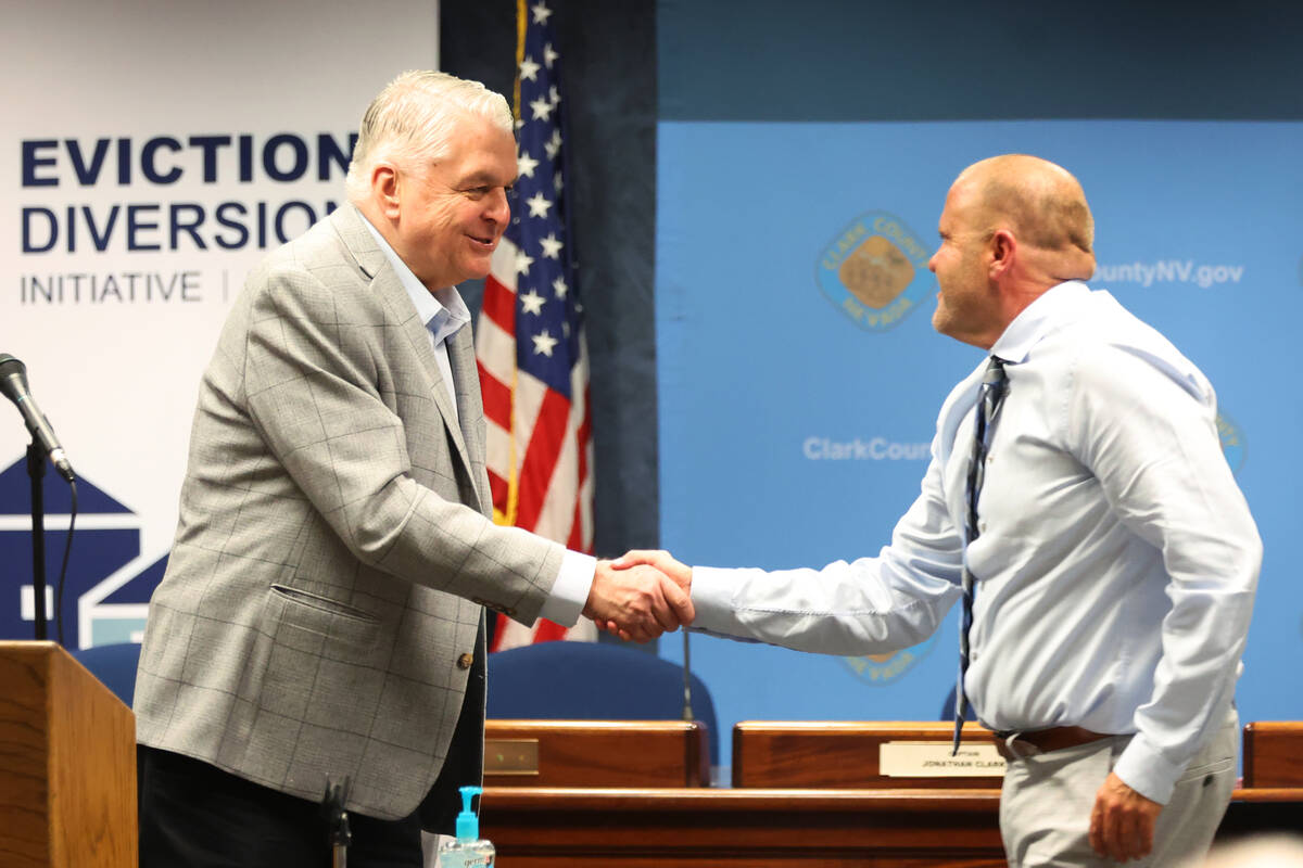 Gov. Steve Sisolak, left, introduces Deputy County Manager Kevin Schiller during a press confer ...