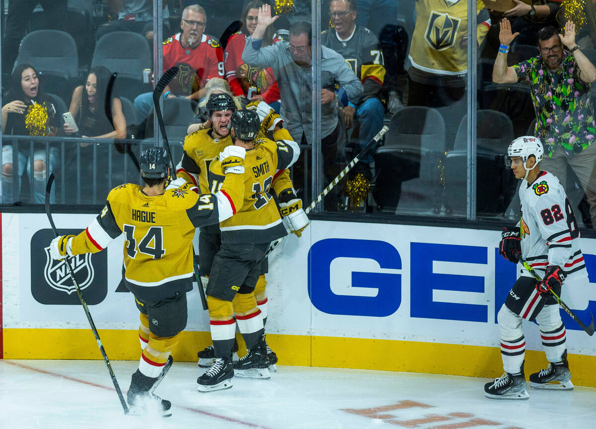 Golden Knights center Paul Cotter (43) celebrates his score with right wing Reilly Smith (19) a ...