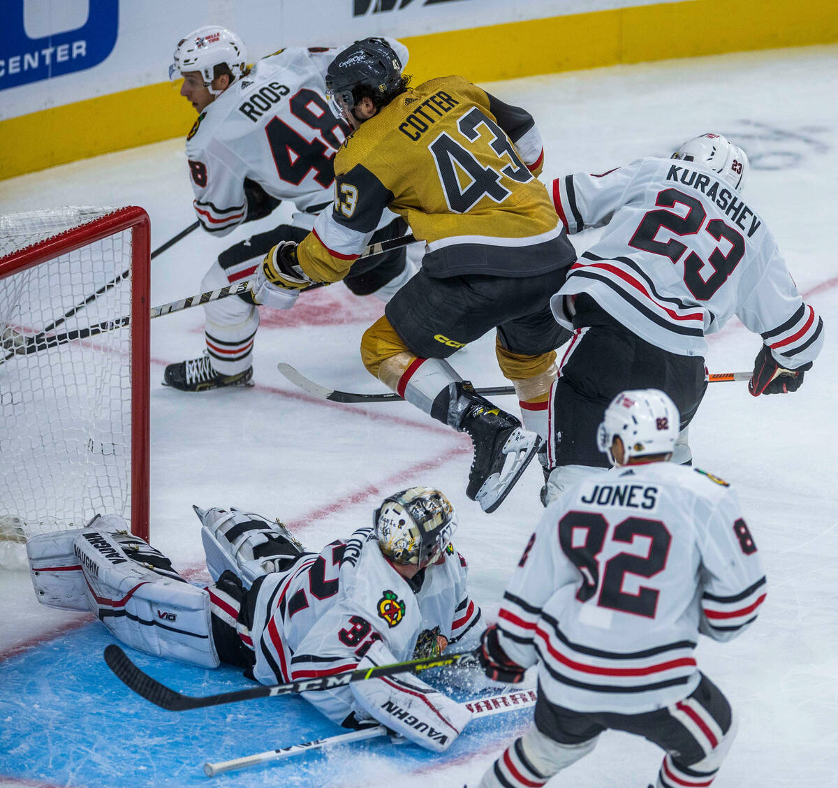 Golden Knights center Paul Cotter (43) catches some air chasing the puck over Chicago Blackhawk ...