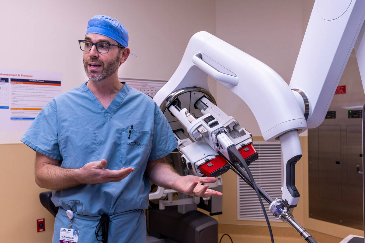 Dr. Garrett Friedman stands by a da Vinci SP surgical robot in an operating room of the Las Veg ...