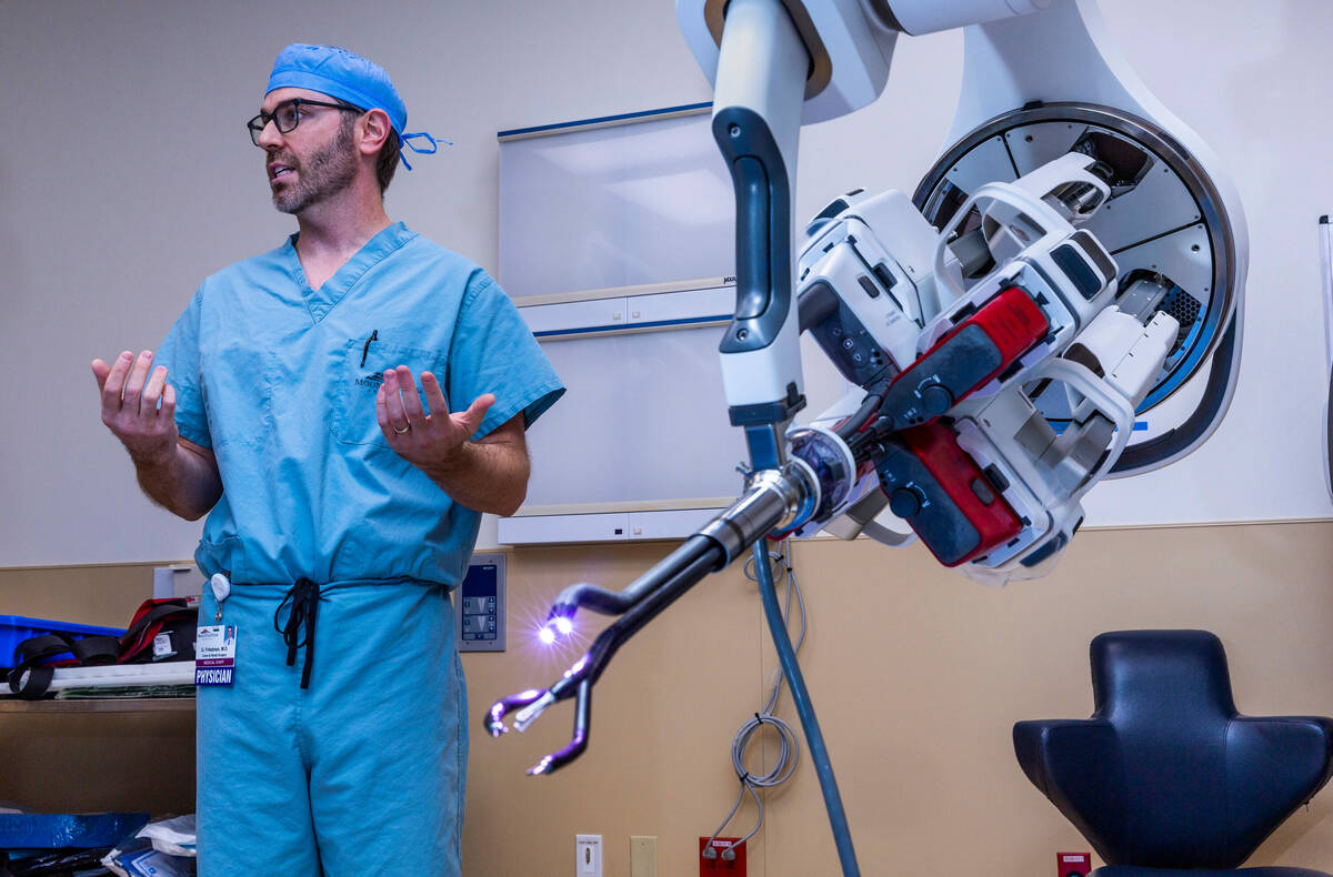 Dr. Garrett Friedman stands by a da Vinci SP surgical robot in an operating room of the Las Veg ...