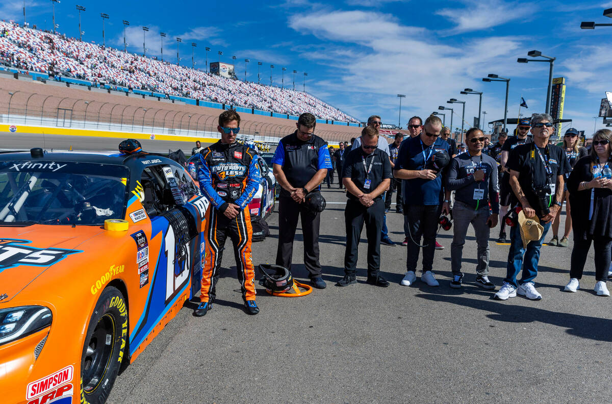 Matt Jaskol (13) prays beside other before the race start for the Alsco Uniforms 302 NASCAR Xfi ...