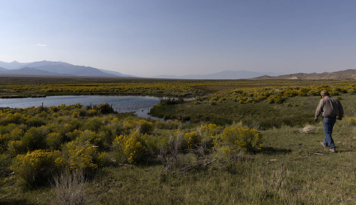 Rancher Tom Baker walks around a pond on his ranch on Friday, Sept. 9, 2022, in Garrison, Utah. ...