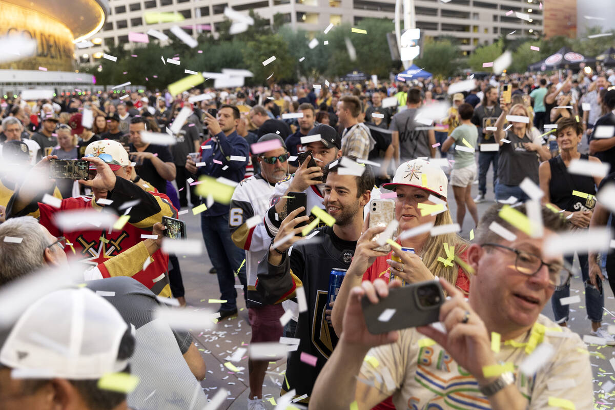 Confetti rains down on fans before an NHL hockey game between the Golden Knights and the Blackh ...