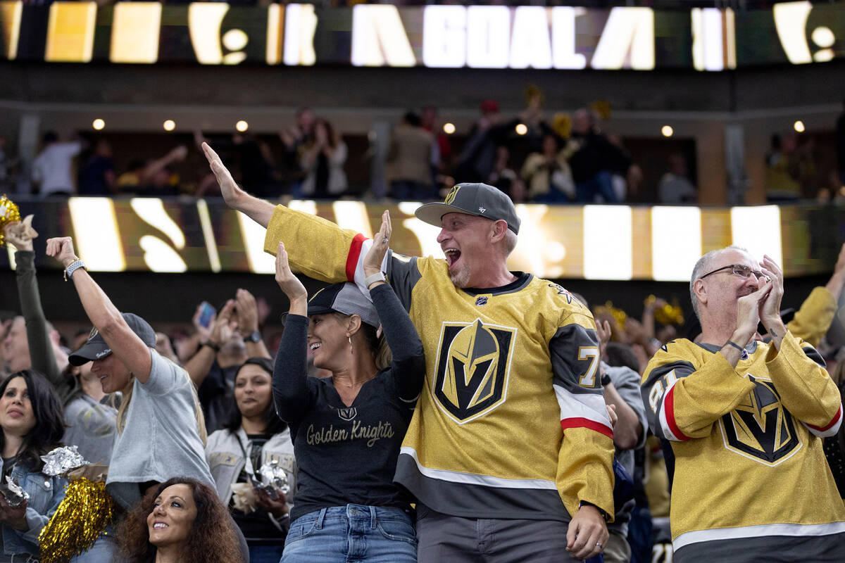 Golden Knights fans celebrate after center Paul Cotter (43) scored against the Blackhawks durin ...