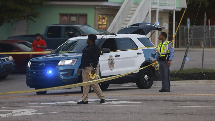 Law enforcement officers block off Old Milburnie Road during a shooting in Raleigh, N.C., Thurs ...