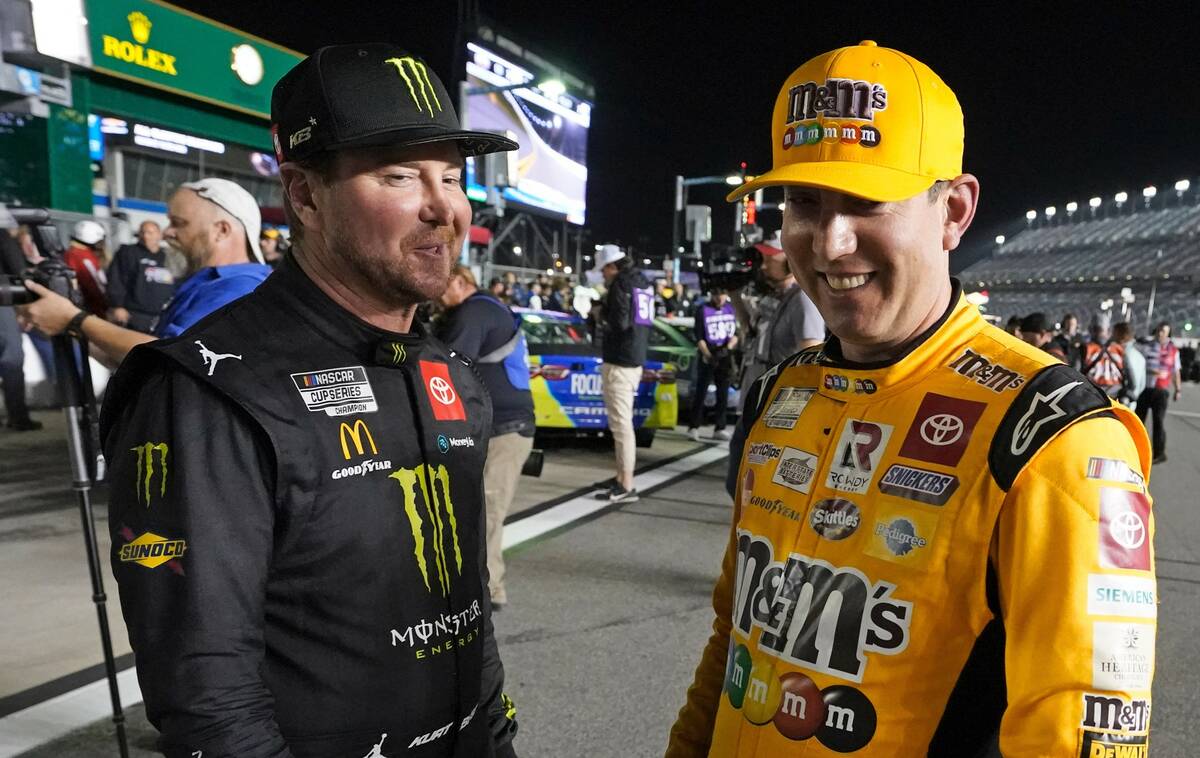 Kurt Busch, left, and Kyle Busch talk on pit road during qualifying for the NASCAR Daytona 500 ...