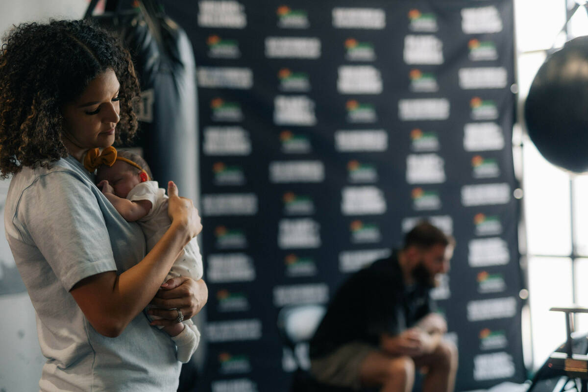 Jordan Plant holds her daughter, Charly, while her husband, former IBF super middleweight champ ...