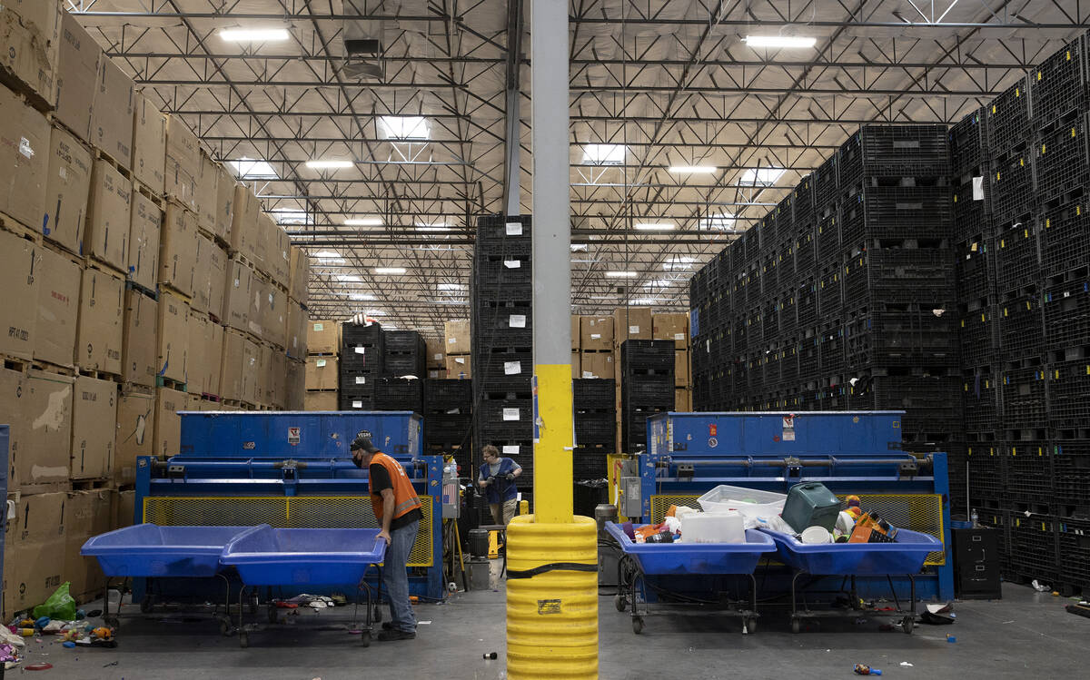 Employees sort items at the Goodwill Distribution Center on Friday, Oct. 14, 2022, in Las Vegas ...