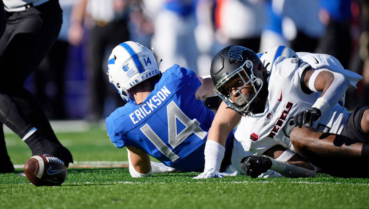 UNLV kick returner Nohl Williams, right, fumbles the football after being hit by an Air Force p ...