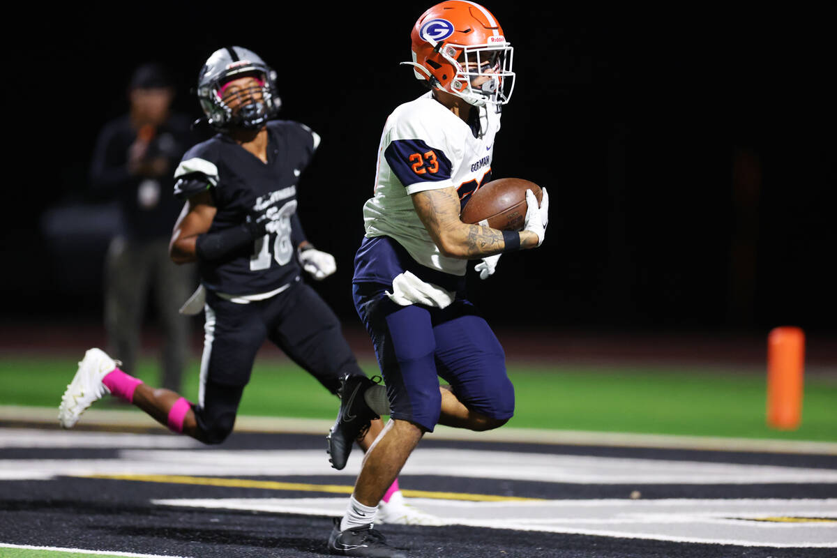 Bishop Gorman's Trech Kekahuna (23) runs the ball for a touchdown after a catch during the firs ...