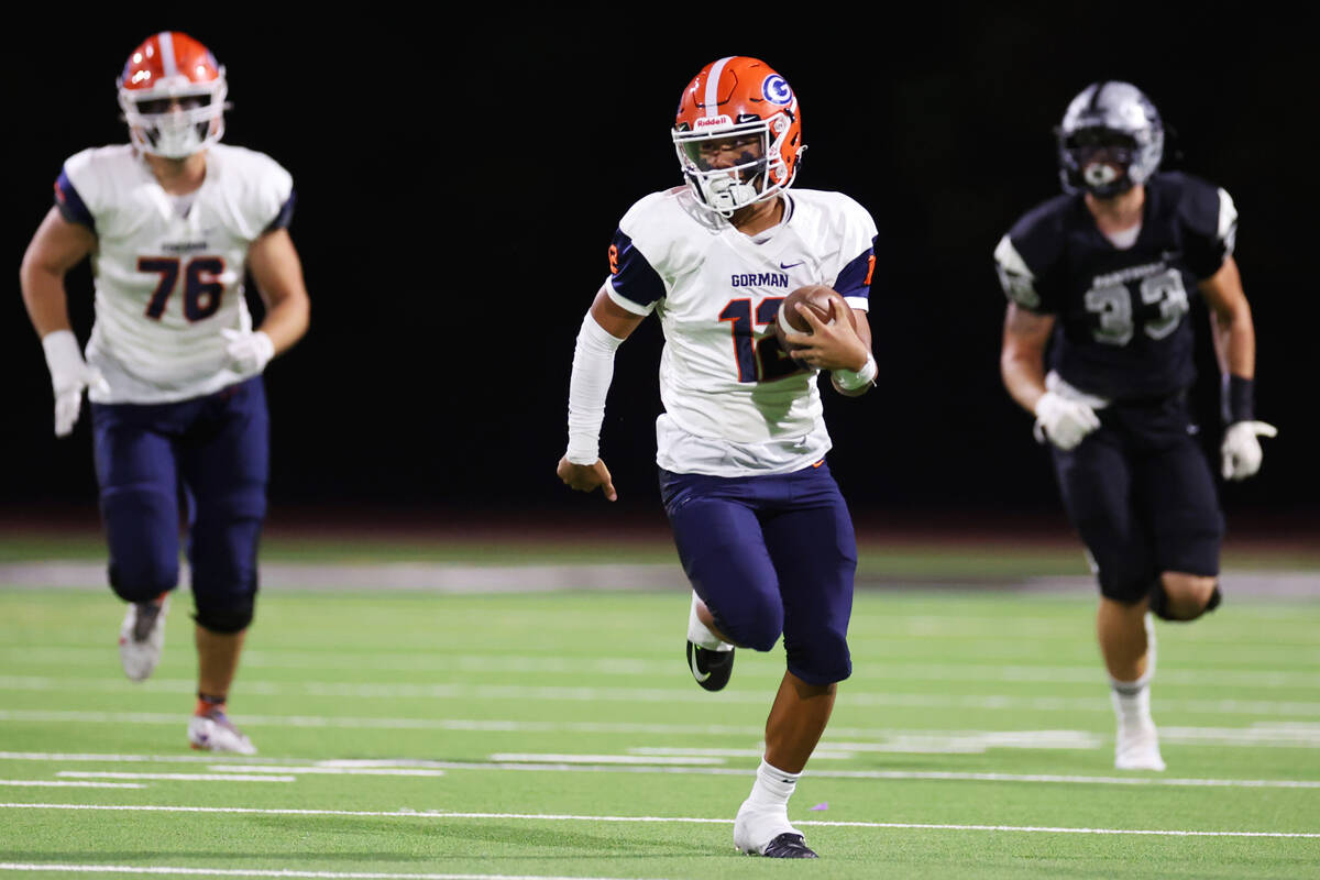 Bishop Gorman's Micah Alejado(12) runs the ball for a touchdown during the first half of a foot ...