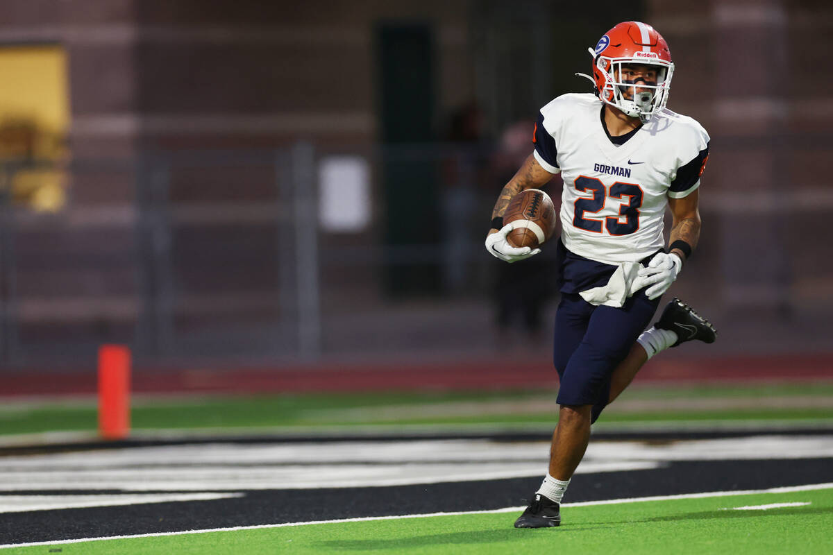 Bishop Gorman's Trech Kekahuna (23) runs the ball for a touchdown after a catch during the firs ...