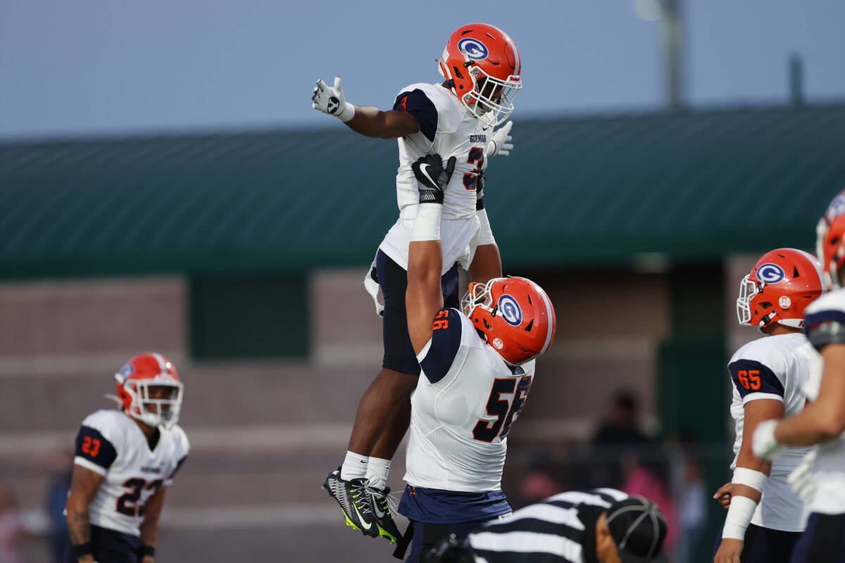 Bishop Gorman's Devon Rice (3) celebrates a ruling touchdown with Zak Yamauchi (56) during the ...