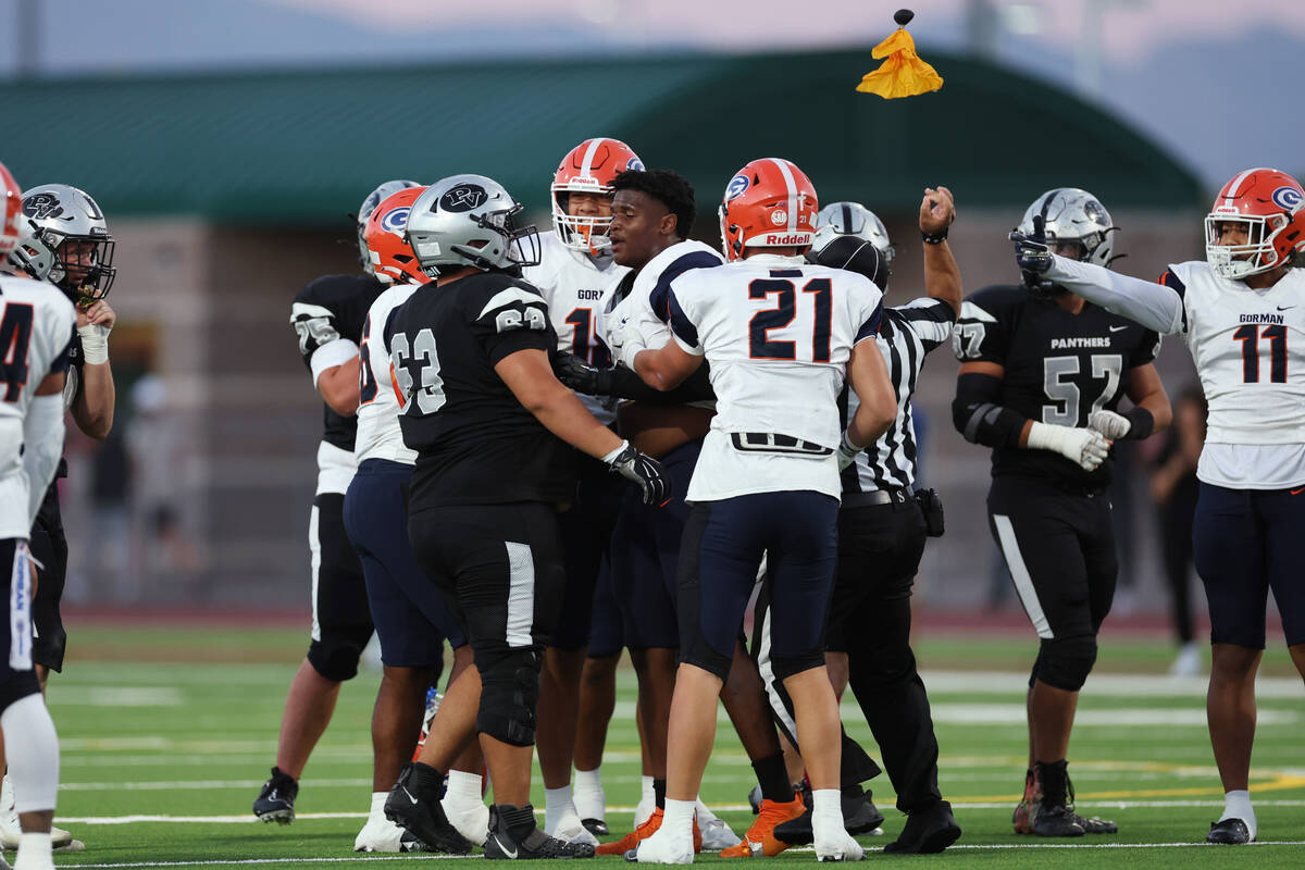 Palo Verde's Tony Sarukhanyan (63) knocks the helmet off Bishop Gorman's Jayden House (8) durin ...