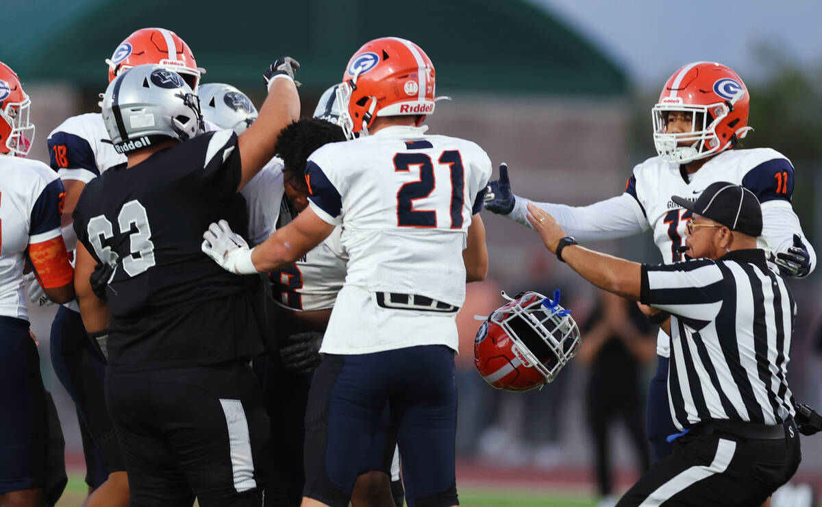 Palo Verde's Tony Sarukhanyan (63) knocks the helmet off Bishop Gorman's Jayden House (8) durin ...