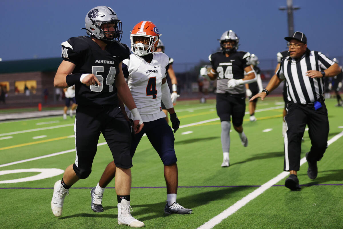Palo Verde's Dustin Kane (54) and Bishop Gorman's Elijah Palmer (4) exchange words after a play ...