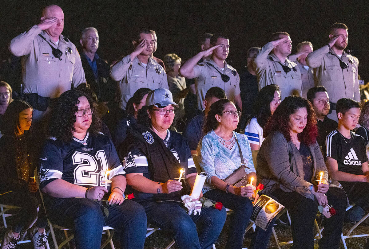 Jada Thai, left seated, the daughter of fallen Las Vegas officer Truong Thai, her mother Angela ...