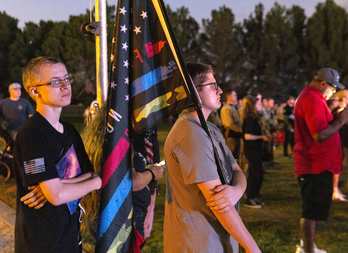 Kenneth Condon, left, and his brother Conner gathered during a candlelight vigil for fallen Las ...