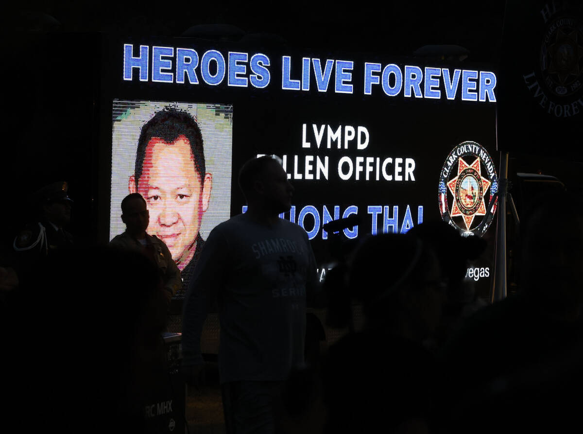 People gathered during a candlelight vigil for fallen Las Vegas police officer Truong Thai, on, ...