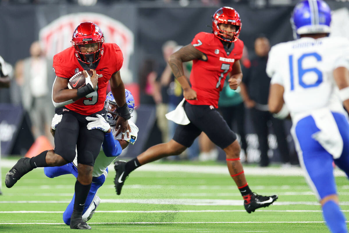 UNLV Rebels running back Aidan Robbins (9) gets tackled by Air Force Falcons safety Trey Taylor ...