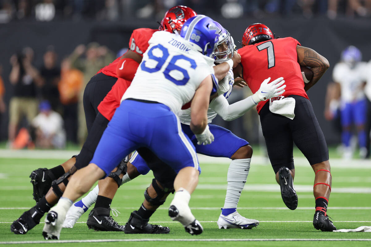 Air Force Falcons linebacker PJ Ramsey (13) tackles UNLV Rebels quarterback Cameron Friel (7) d ...
