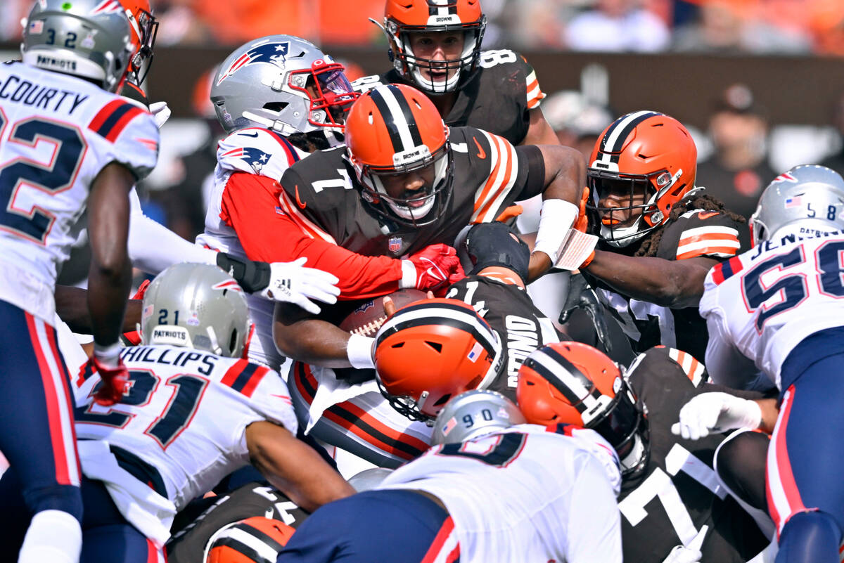 Cleveland Browns quarterback Jacoby Brissett (7) is stopped by the New England Patriots defense ...