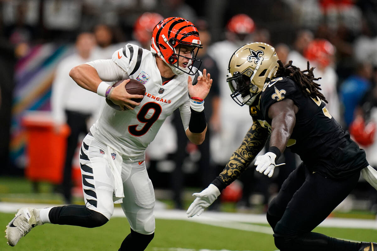 Cincinnati Bengals quarterback Joe Burrow (9) is sacked by New Orleans Saints linebacker Demari ...