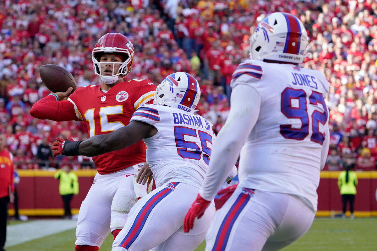 Kansas City Chiefs quarterback Patrick Mahomes (15) throws under pressure from Buffalo Bills de ...