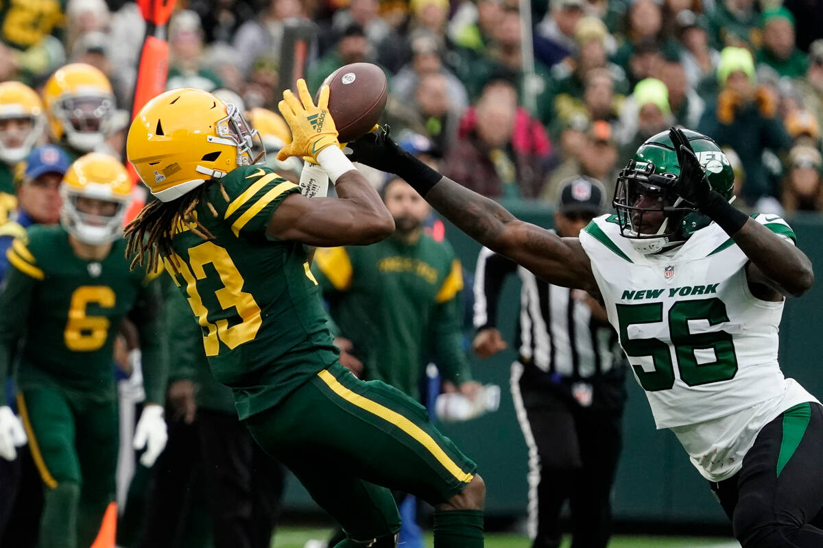 New York Jets linebacker Quincy Williams (56) forces Green Bay Packers running back Aaron Jones ...
