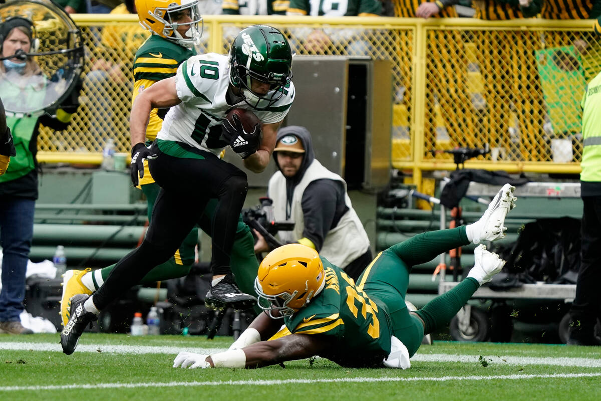 New York Jets wide receiver Braxton Berrios (10) runs over Green Bay Packers safety Adrian Amos ...
